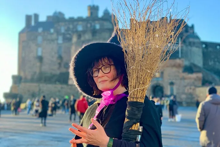 Character guide telling witch stories to a group on an Edinburgh ghost tour near Grassmarket, Old Town, Scotland