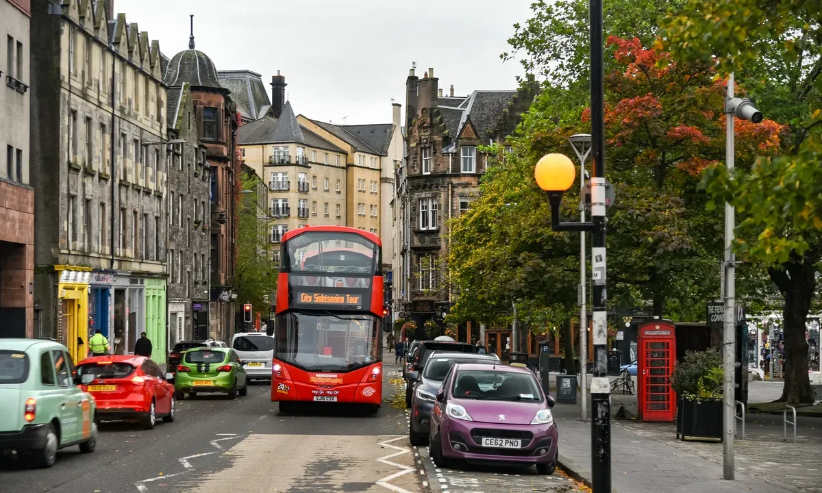 A double-decker bus on the Grassmarket below the castle, the old execution site on many Edinburgh ghost tour routes, Edinburgh ghost tours, Edinburgh, Scotland